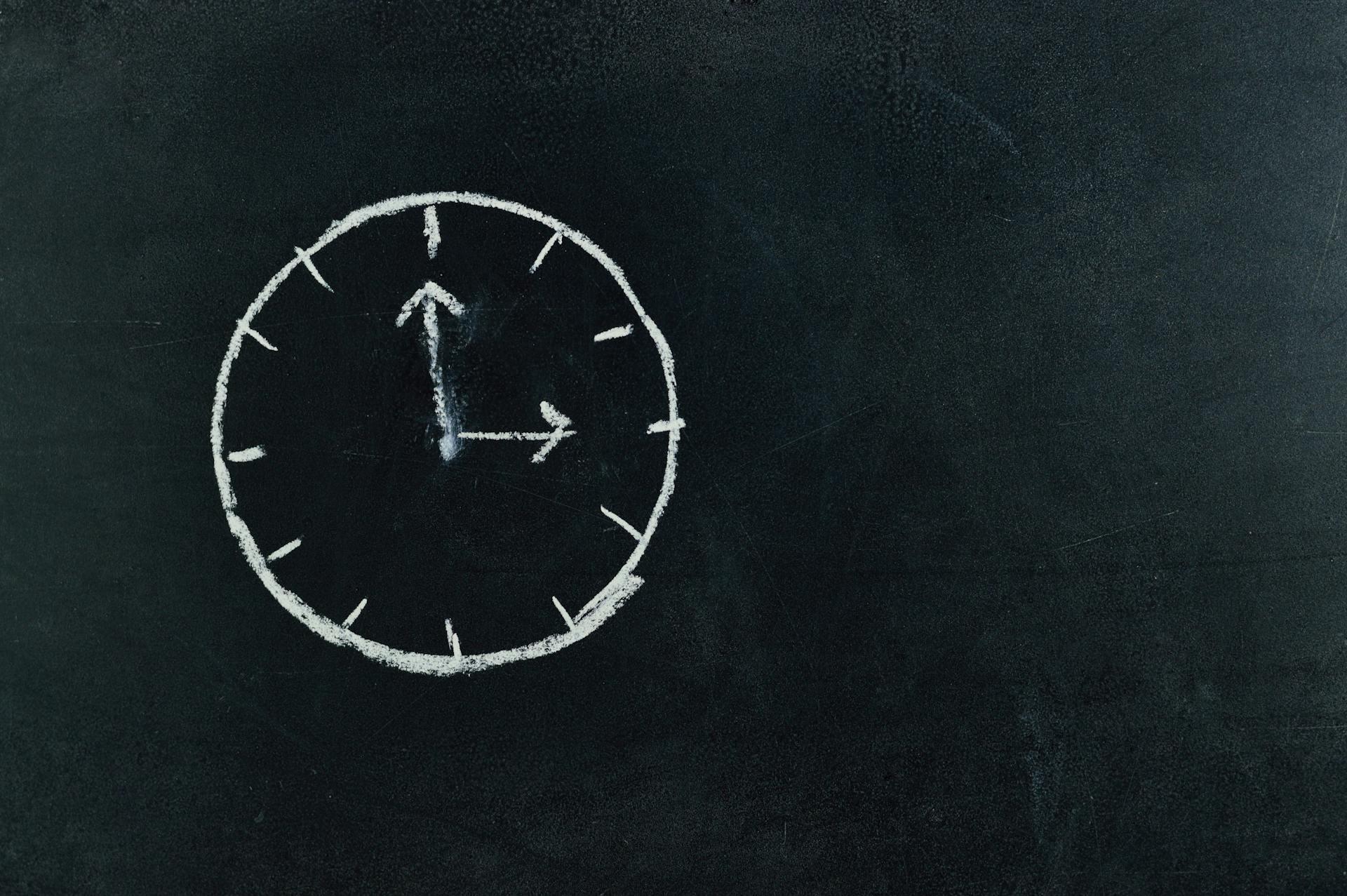 Drawn image of a clock on chalkboard