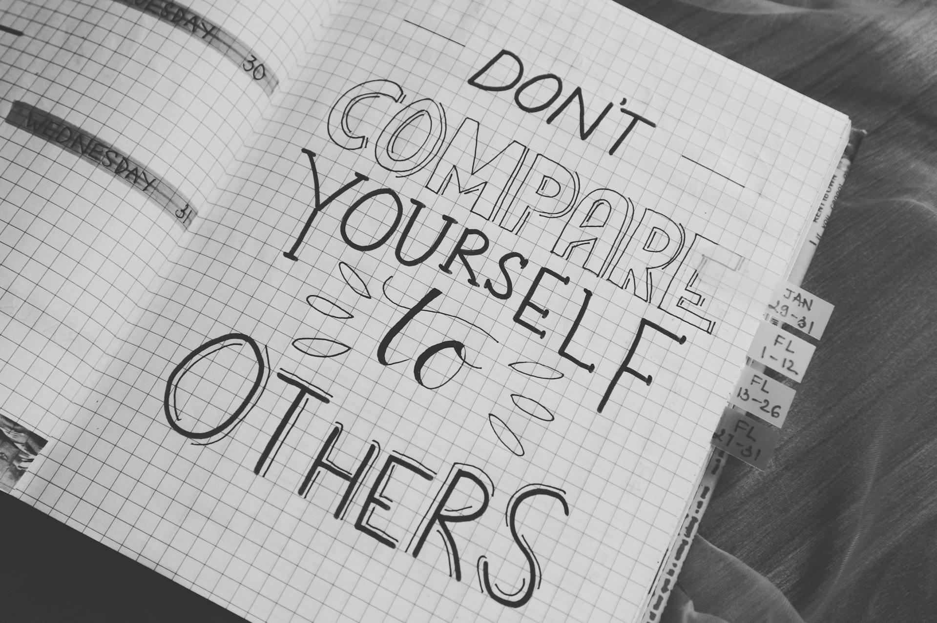 Notebook with drawn don't compare yourself to others quote